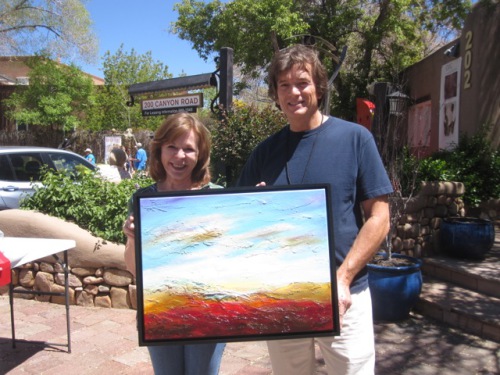 Michael Ethridge and Aleta Pippin showing off Michael's painting