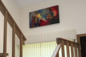 A colorful painting by Aleta Pippin graces D'Ambra's Stamford home.